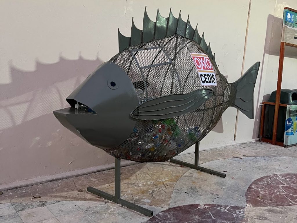 a fun recycling can in the shape of a fish in Tulum, mexico